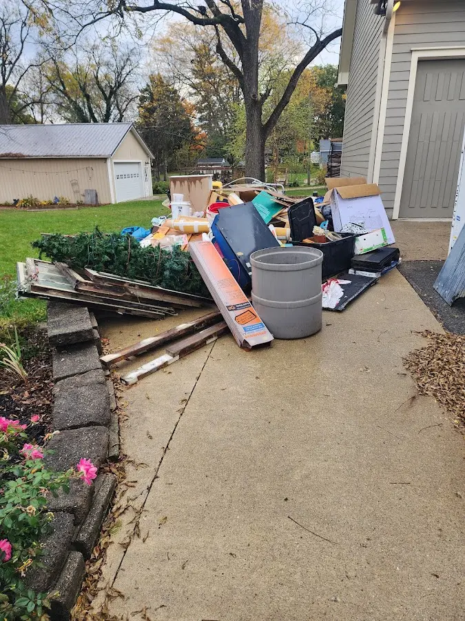 Dumpster being loaded with debris for Estate Cleanout Dumpster Rental in Lake Wissota